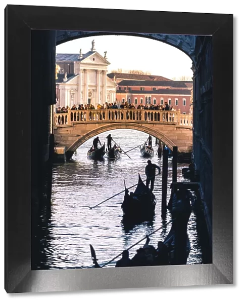 Venice, Veneto, Italy. Gondolas passing under the Bridge of Sighs