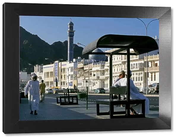 Omanis walk and sit alongside Muttrahs busy Corniche