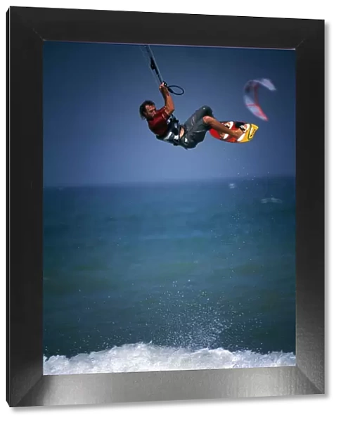 A kitesurfer makes a large tailgrab jump off Masirah