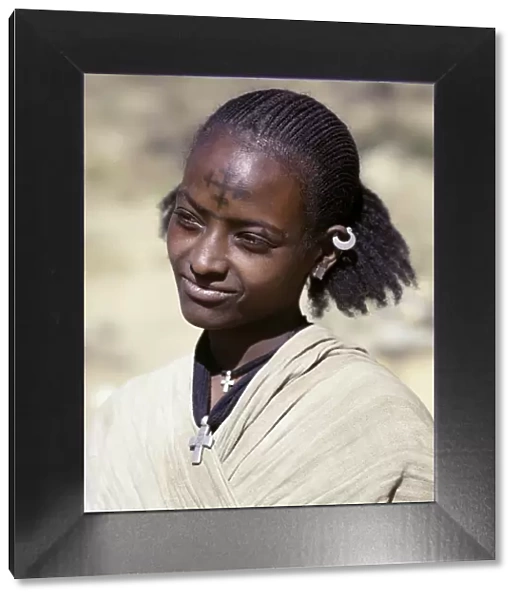 A Tigray woman has a cross of the Ethiopian Orthodox