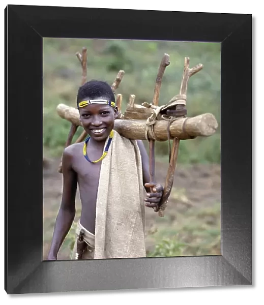 A Konso youth of southwest Ethiopia carries home a