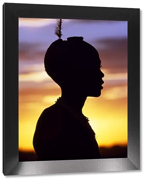 A young Dassanech boy silhouetted against the evening