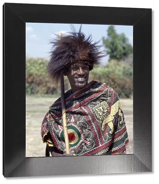An Ethiopian man wears a headdress made from the skin of a gelada