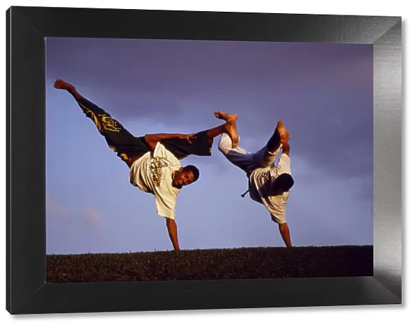 Two boys practice Capoeira, the Brazilian martial art
