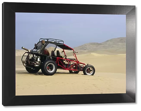 A dune buggy sits in the desert expense of Peru s