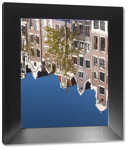 Holland, Amsterdam, traditional Gabled houses reflected in canal