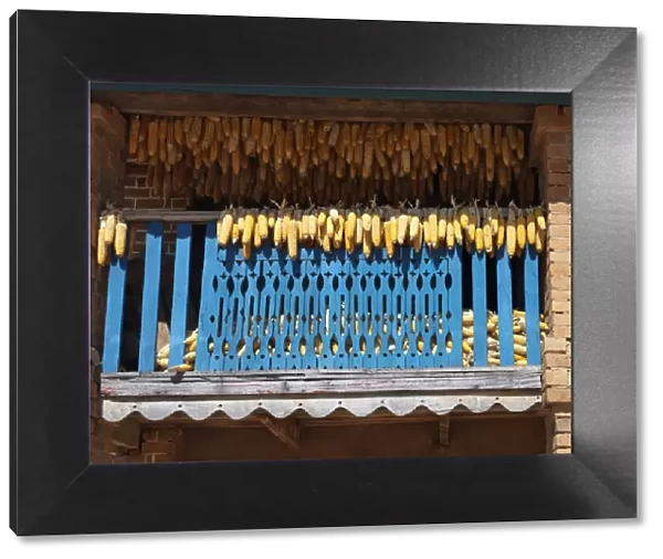 Maize cobs drying on the balcony of a traditional Betsileo double-storied house