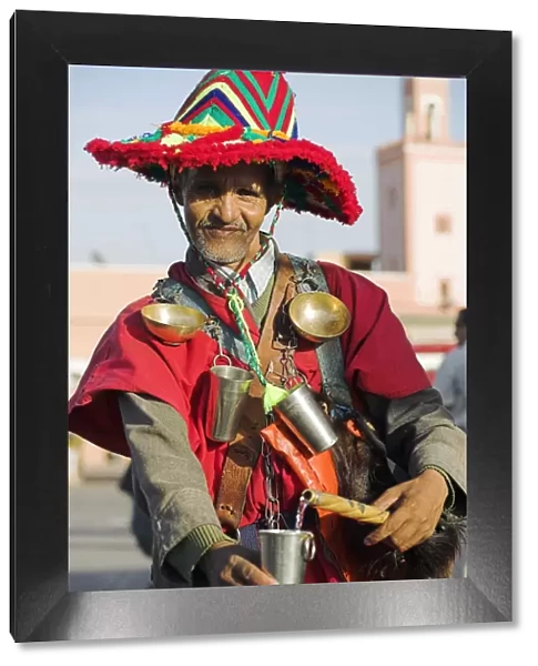 A Moroccan water seller in traditional dress in the Djemaa el Fna
