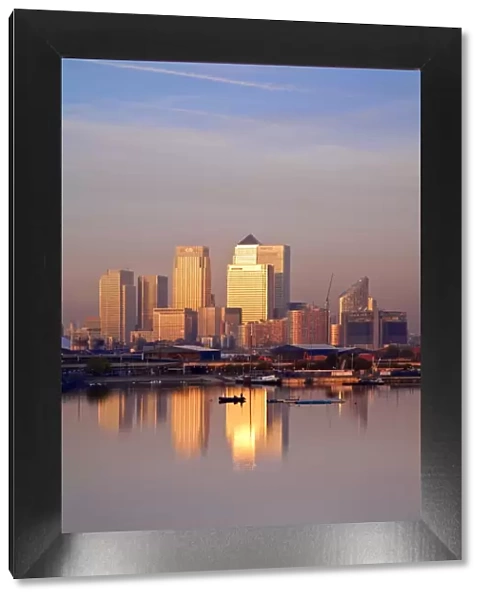 England, London, Newham, Royal Victoria Docks, Canary Wharf buildings at dawn