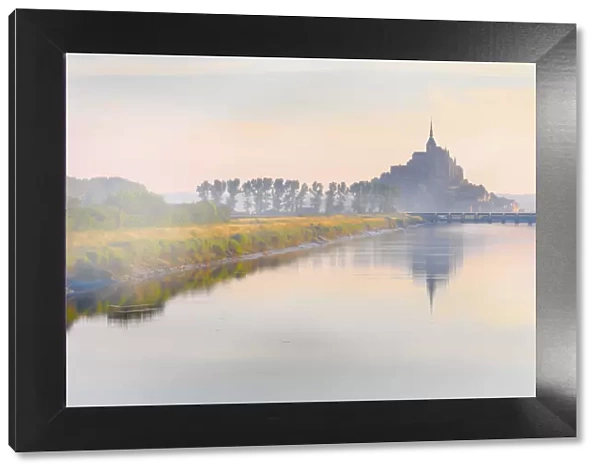 France, Normandy, Le Mont Saint Michel, shrouded in fog at dawn, reflected in river