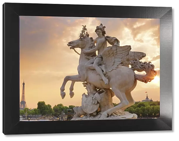 France, Paris, Jardin de Tuileries, statue and Eiffel Tower in the background at dusk