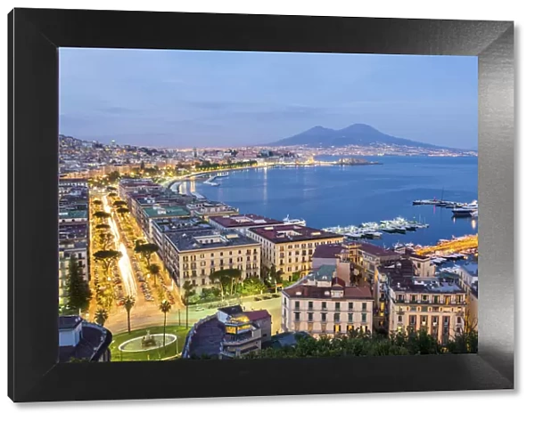 Naples, Campania, Italy. View of the bay by night and Mount Vesuvius Volcano in background