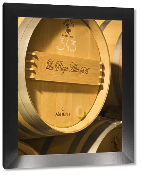 Spain, La Rioja, Haro. Storage barrels at La Rioja Alta, a traditional Rioja winery