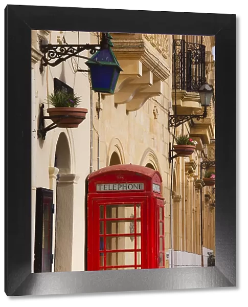 Malta, Gozo Island, Gharb, village square with police station and British telephone box