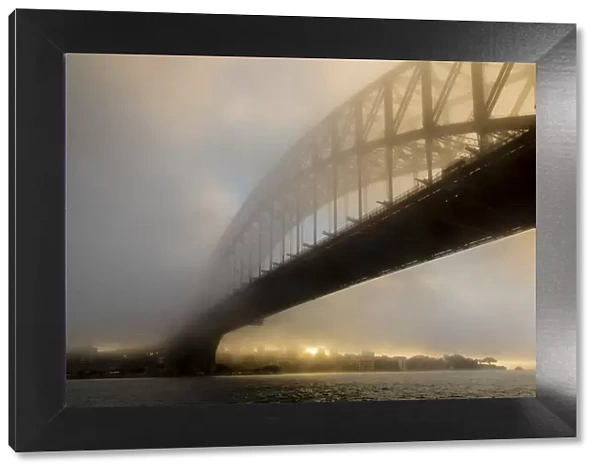 Sydney Harbour Bridge in fog at sunrise, Sydney, New South Wales, Australia