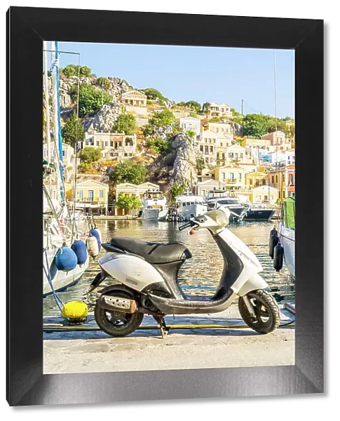 A scooter by the colourful harbour in Symi, Dodecanese Islands, Greece