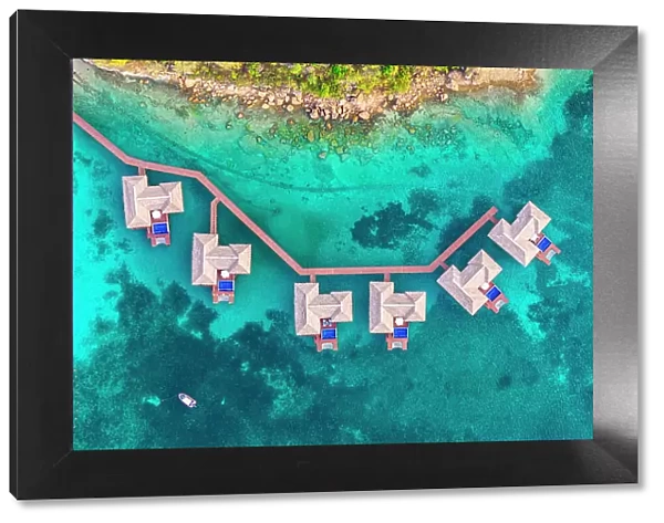 Overwater luxury bungalows with private pool in the crystal clear sea, aerial view, Antigua, Antigua & Barbuda, Caribbean