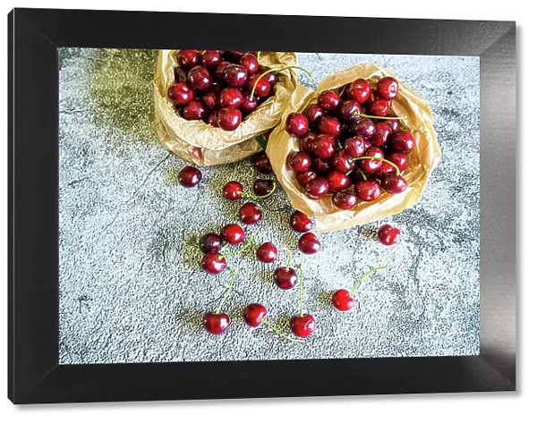 Red cherries ready to eat on a table, high angle view