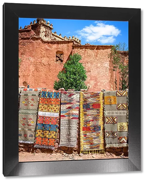 Handmade carpets for sale hanging outside the old ruins of Telouet Kasbah, High Atlas mountains, Morocco