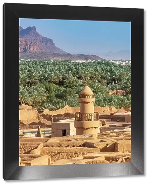 Old mosque minaret, Date palms and old town ruins in the Oasis of Al-Ula, Medina Province, Saudi Arabia