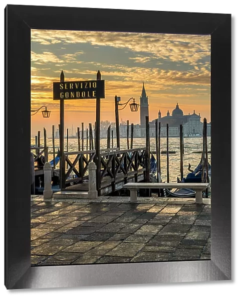 Gondola service sign and Church of San Giorgio Maggiore in the background at sunrise Venice, Veneto, Italy