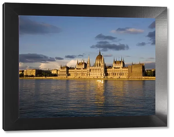 Hungary, Budapest. The Parliament Building by the River Danube, catches the last of the evening sun