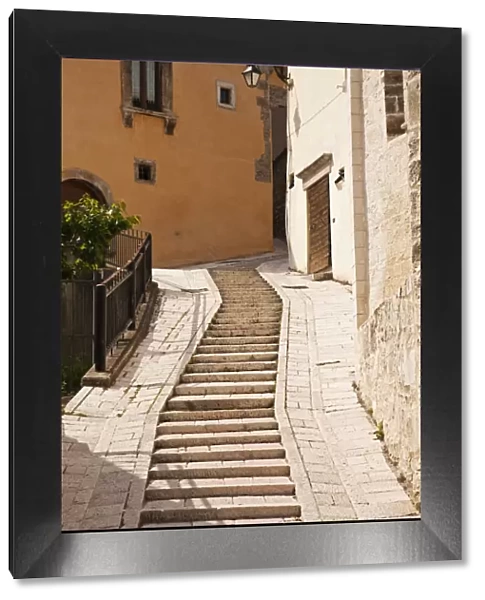 Italy, Umbria, Preci. A narrow street in Preci, known throughout Europe in the sixteenth century for its school for surgeons, founded by Benedictine monks, their main trade being the removal of kidney stones, eye surgery
