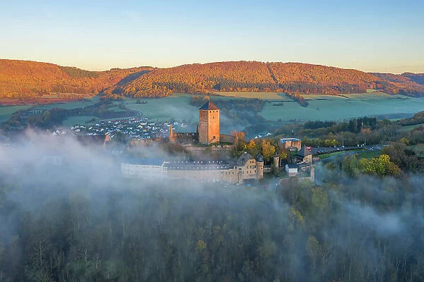 Aerail view at Lichtenberg castle in morning fog, Thallichtenberg, Rhineland-Palatinate, Germany