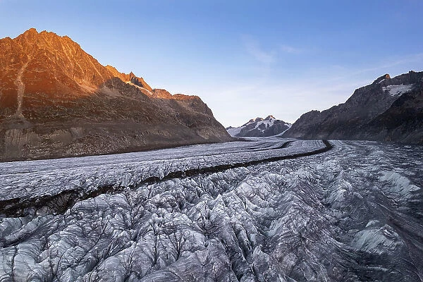 Aerial shot of Aletsch swiss glacier with crevasses and ice cracks at sunset, Aletsch glacier, Bernese Alps, Valais canton, Switzerland