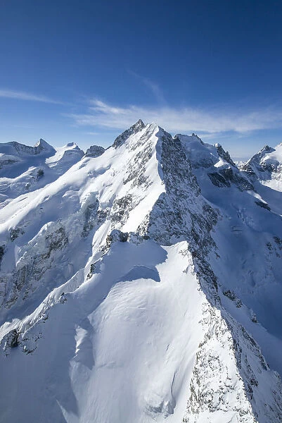 Aerial view of the long crest of ice and rock that takes to Bernina peak. Engadine
