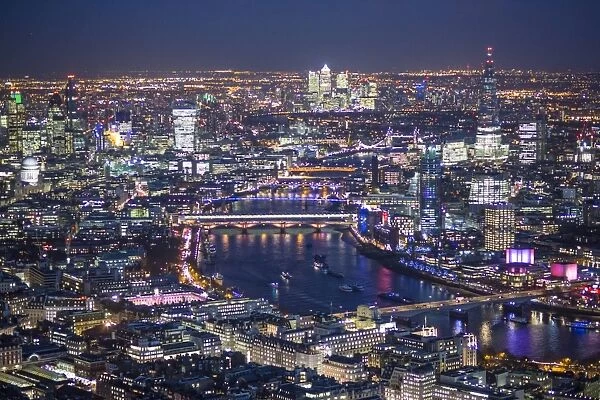 Aerial view over River Thames, City of London, The Shard and Canary Wharf, London