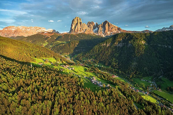 Aerial view of Sassolungo group, Sassopiatto, Gardena Valley and at sunset in spring, Dolomites, South Tyrol, Italy