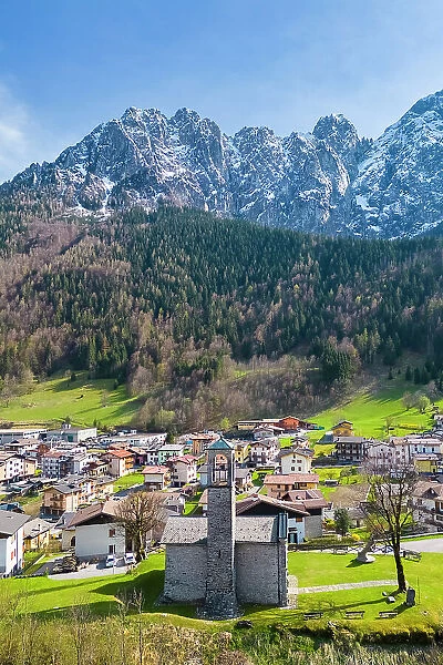 Aerial view of the small church called Cesuli in Colere town with view of the north face of the Presolana mountain in spring. Colere, Val di Scalve, Bergamo district, Lombardy, Italy, Southern Europe