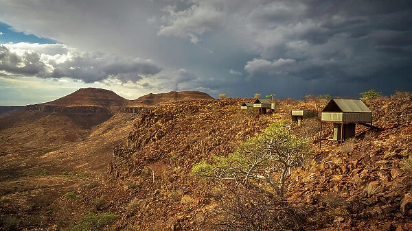 Africa, Namibia, Damaraland, Etendeka Plateau. A thunderstorm over the landscape near to the tented camp