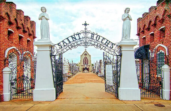 Angels guard the entrance to St Rochs Cemetery in the Bywater district of New Orleans. Saint Roch is the Patron Saint Of Miraculous Cures and many sick believers have come here hoping for a cure. Louisiana, USA