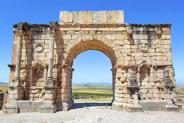 The 'Arch of Caracalla' (Triumphal Arch) in the ancient Roman ruins of Volubilis, near Meknes, Morocco