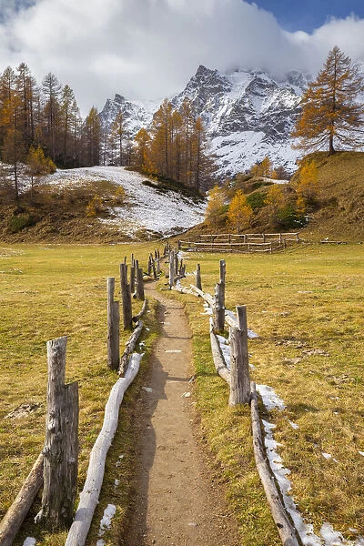 Autumnal view of a trail leading to the mountains surrounding Alpe Devero from Crampiolo