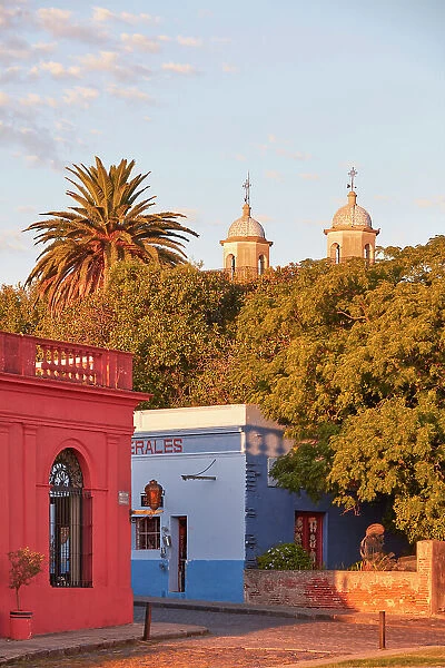The 'Basilica of the Holy Sacrament' tower bells and colonial buildings at sunset, Colonia del Sacramento, Uruguay. Colonia was declared UNESCO World Heritage Site in 1995
