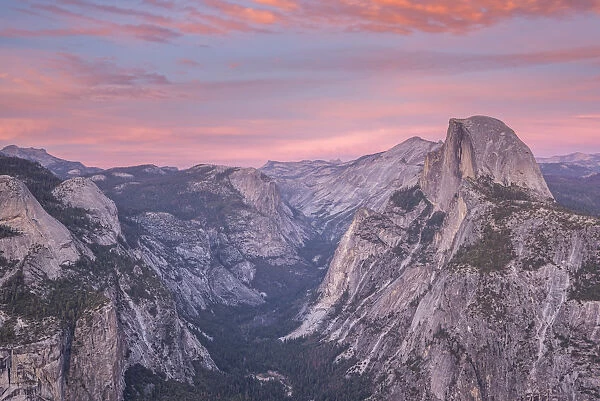 Beautiful pink sunset above Half Dome and Yosemite Valley, viewed from Glacier Point