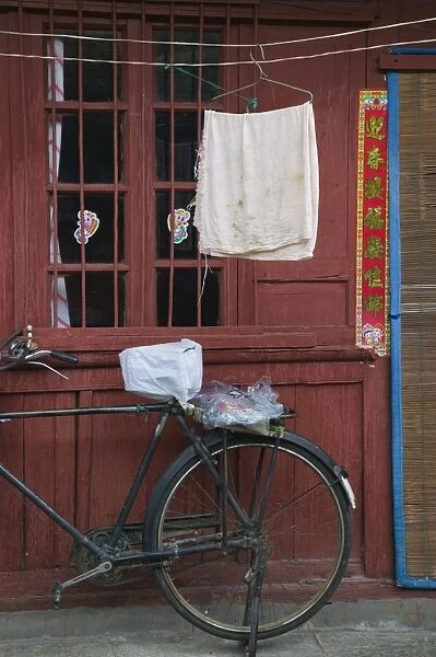 China, Yunnan Province, Dali, Old Town, Bicycle and wall