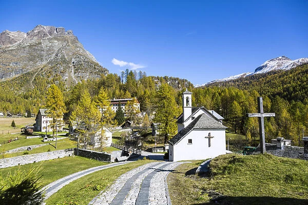 Church and houses in the green landscape of Alpe Devero, Val Formazza