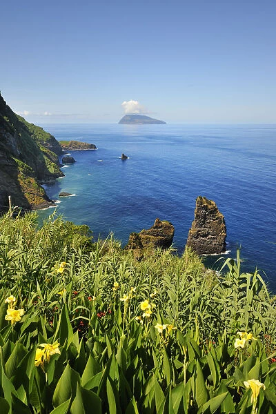 Coastline and the Corvo island on the horizon. Flores, Azores islands, Portugal