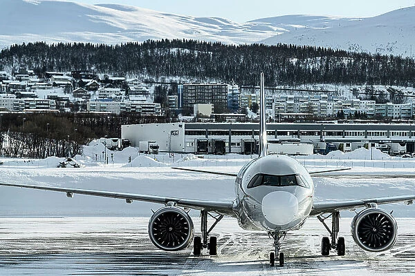 Commercial aircraft in the frozen airport of Tromso in winter, Norway
