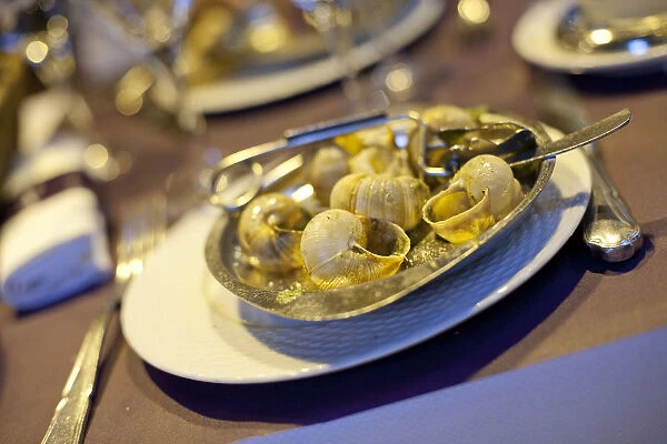 A dish of escargots or snails at a cafe in Paris France