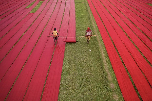 Drying red fabrics under sunlight, Narsingdi, Bangladesh