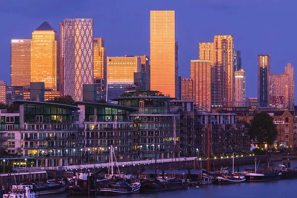 England, London, Docklands, Late Evening Light on Canary Wharf Skyline and River Thames