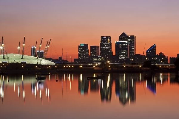 England, London, Newham, O2 Arena and Canary Wharf buildings reflecting in Royal Victoria Docks