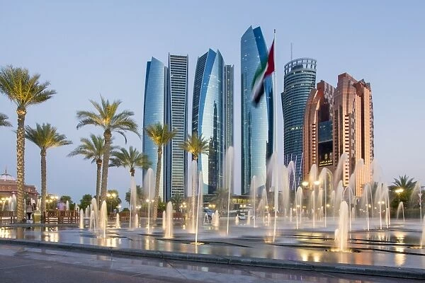 Etihad Towers time lapse viewed over the fountains of the Emirates Palace Hotel, Abu Dhabi