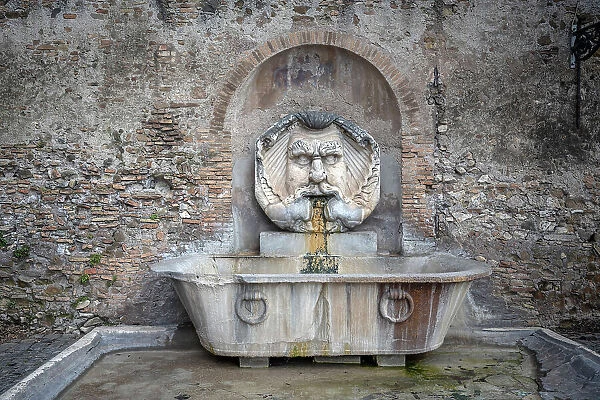 Europe, Italy, Rome. Characteristic fountain with the great mask near the Orange Garden on the Aventine hill