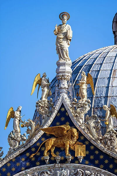 Detail of the facade of St Mark's Basilica showing St. Mark patron apostle with angels and, underneath, the winged lion, Venice, Veneto, Italy